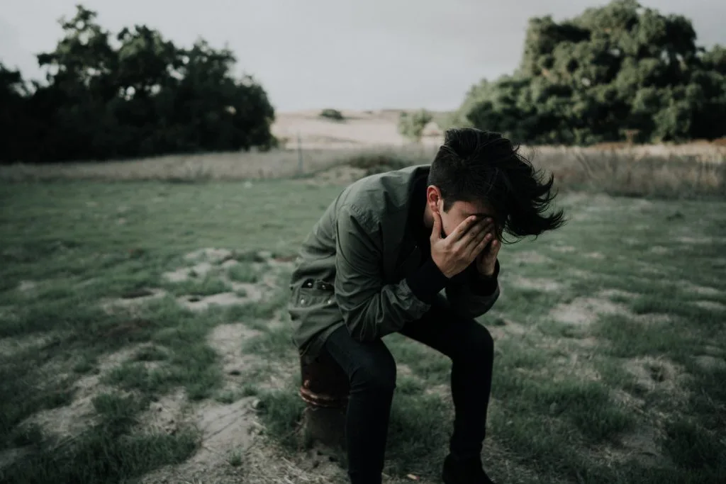 Depressed teenager with head in hands. Florida Collaborative Practice: Clarifying Parents’ Intent About “Mental Health Treatment”