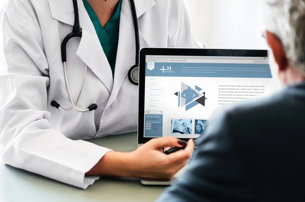Doctor showing laptop information. Parental Responsibility Health Care