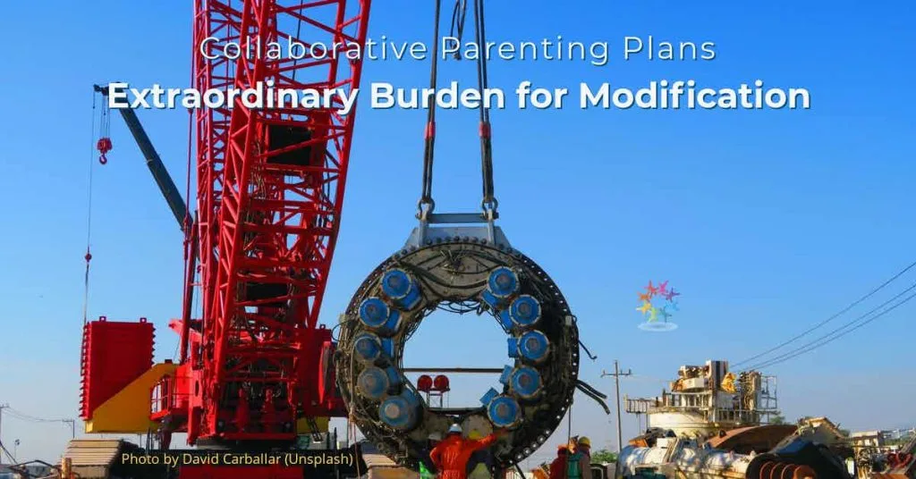 Collaborative Parenting Plans. Extraordinary Burden for Modification. Men standing near red crane hauling large heavy circular object.