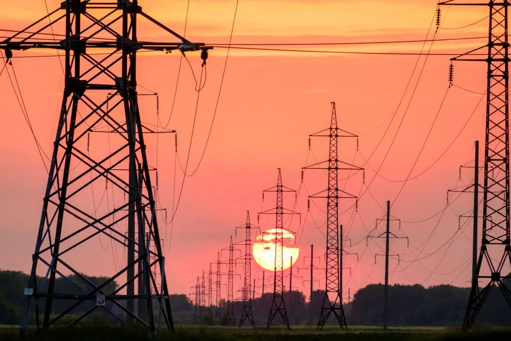 Harness Collaborative Contract Power silhouette of electric posts in sunset.