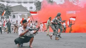 Defense Child Abduction Claims under Hague Convention. Hague Defense Grave Risk of Harm War. Indonesia Men with Guns and flags. Bimo Luki (Unsplash)